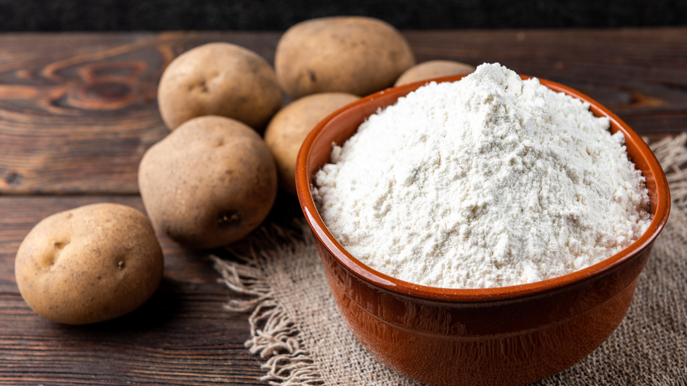 potatoes and flour on a wooden surface