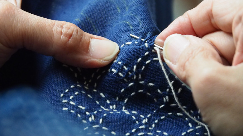 A person sewing 