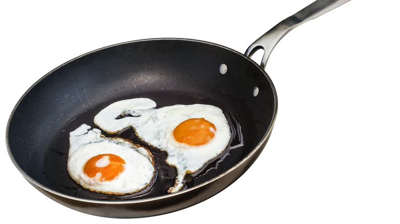 sunny side up eggs in a Teflon pan