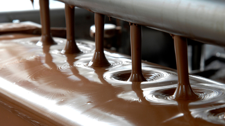 Chocolate pouring from machinery