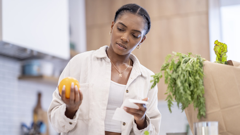 woman comparing receipt to purchases