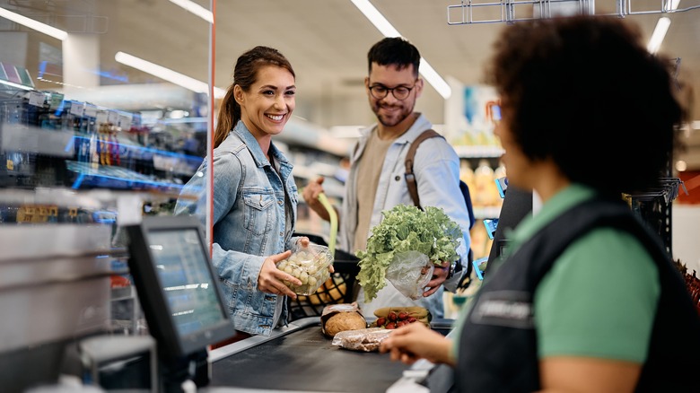 grocery store shoppers checking out