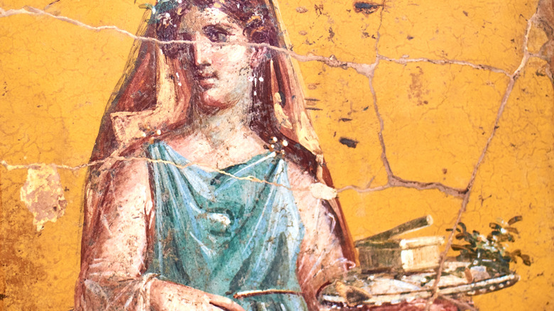 fresco of roman woman holding food