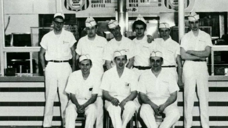 A crew of men dressed in white shirts