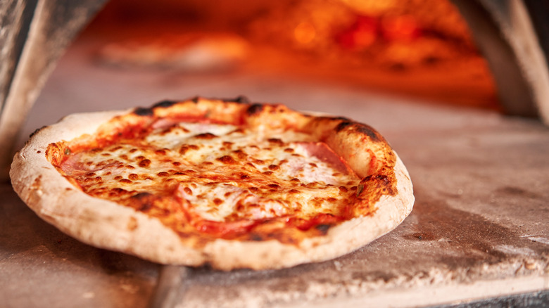 Neapolitan pizza next to oven