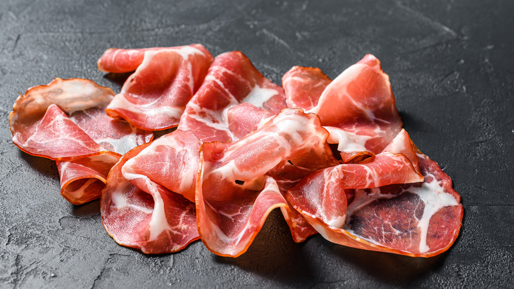 Italian pancetta on a black background