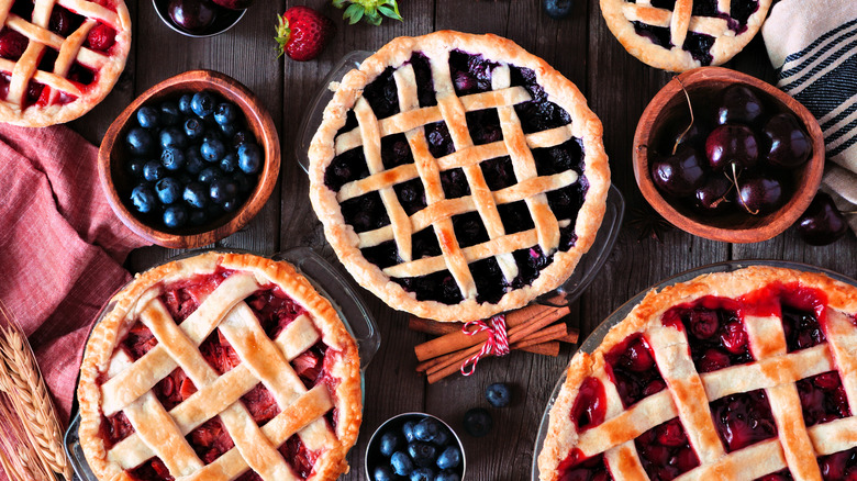 Lattice-crust pies and bowls of fruit