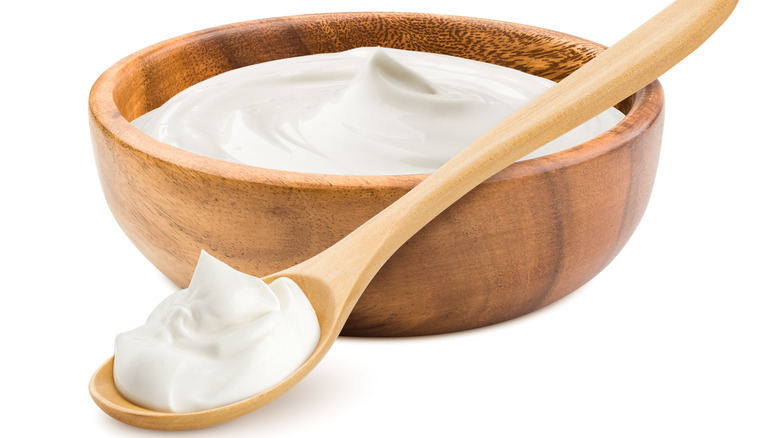 Wood bowl with mayo and on a spoon