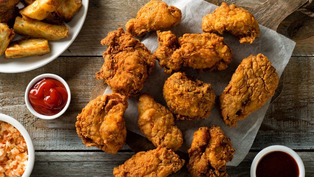 fried chicken on a board with sides