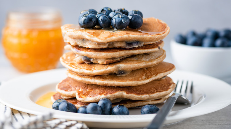 A tall stack of blueberry-topped blueberry pancakes