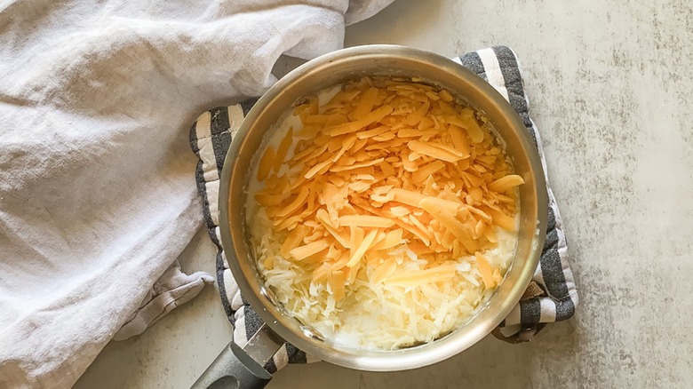 Pot full of shredded cheese 