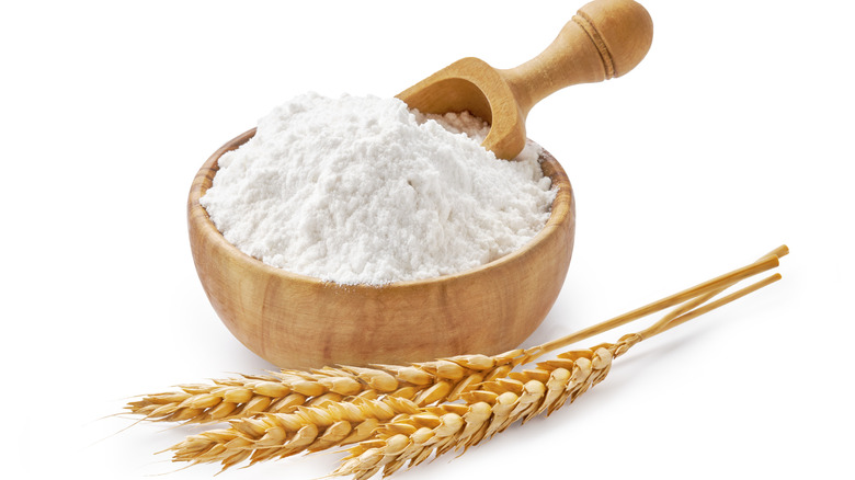 wheat flour in wooden bowl 