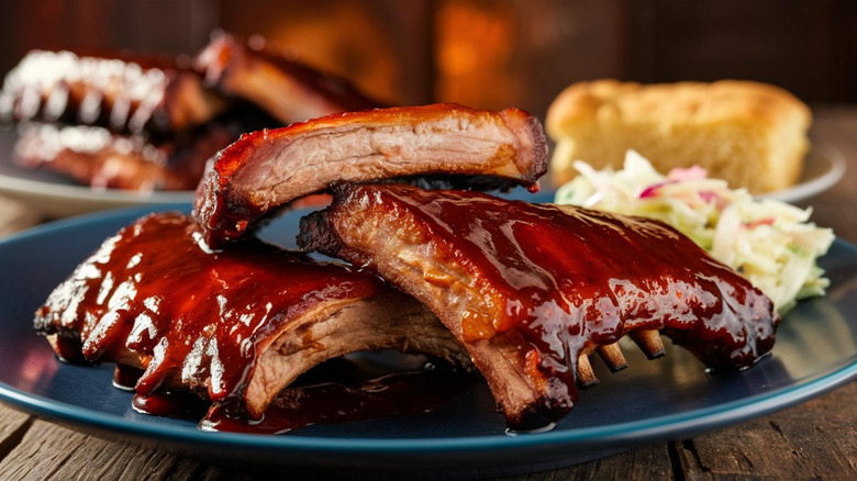 Barbecue ribs on blue plate with coleslaw and bread