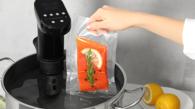 Placing salmon in sous vide machine