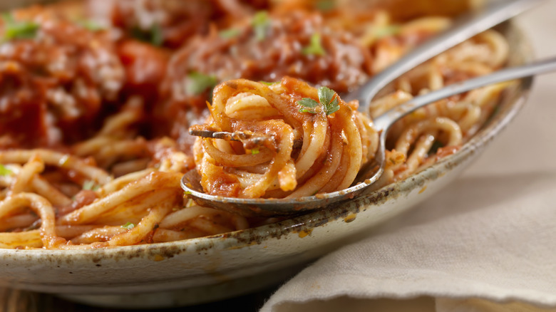 spaghetti and meatballs on spoon