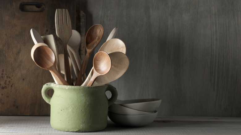 jar of wooden cooking utensils 