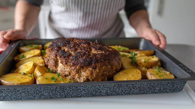 meatloaf on pan with potatoes