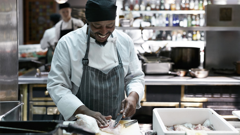 Chef preparing raw fish