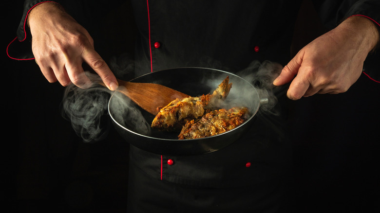 Fried fish cooking in pan