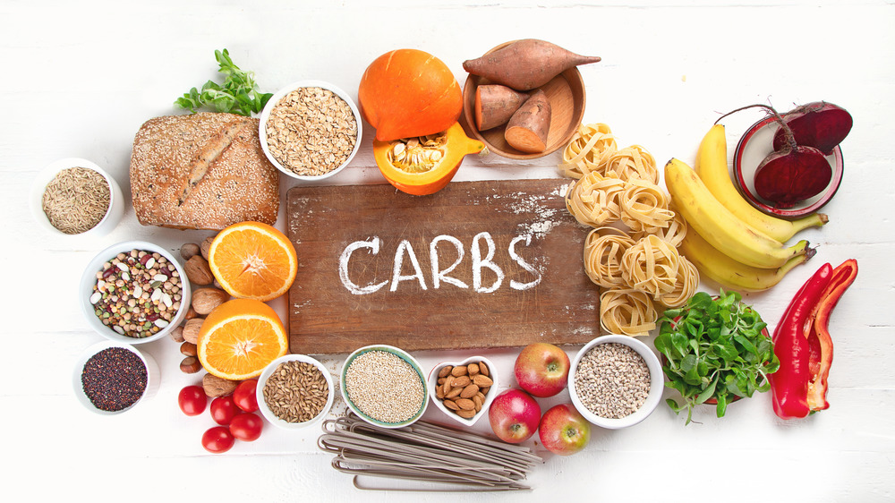 "Carbs" sign surrounded by carb-loaded foods