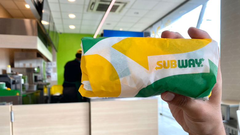 Raising Subway sandwich in empty store