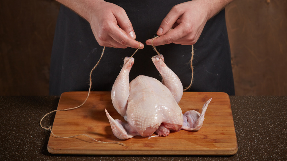 Trussing chicken drumsticks with twine