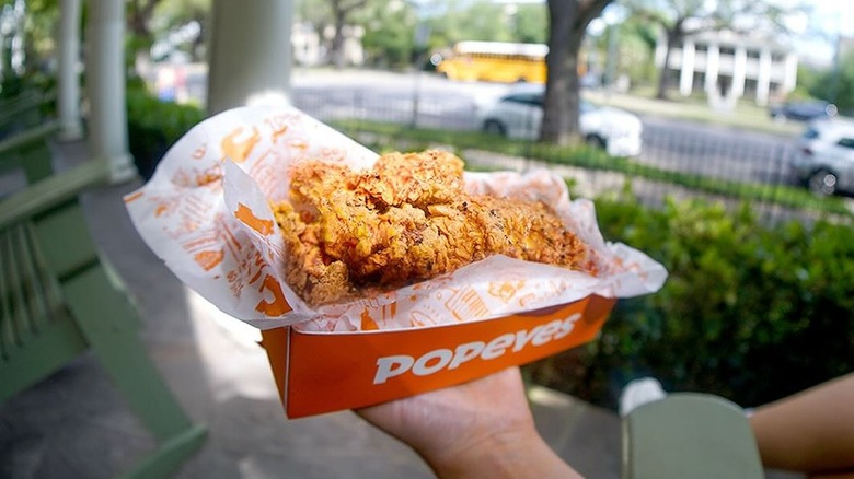 Person holding chicken wings box