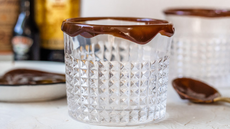 Textured clear glass with chocolate sauce on rim