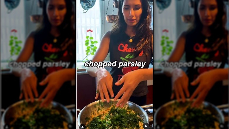 Padma Lakshmi adding parsley to pasta