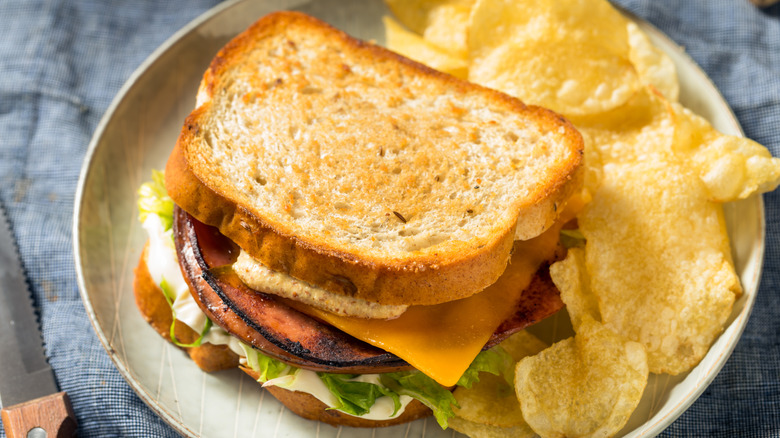 Fried bologna sandwich with chips on plate