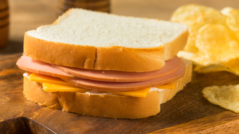 Bologna sandwich with cheese and chips