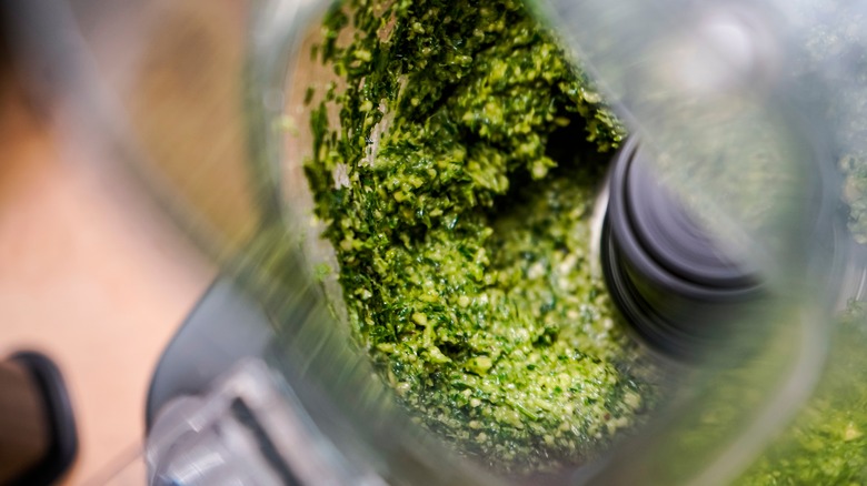 Green pesto sauce in a blender 