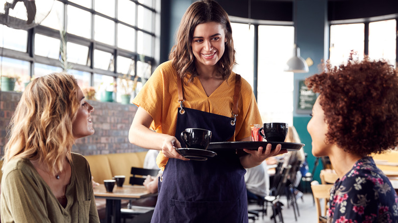 Two women being served at coffee shop