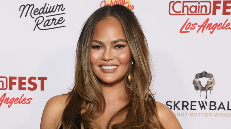 Chrissy Teigen smiling at publicity event