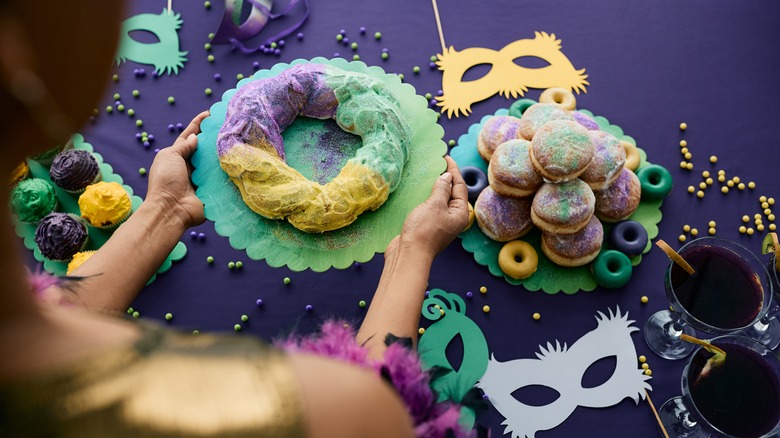 A woman serving a King Cake