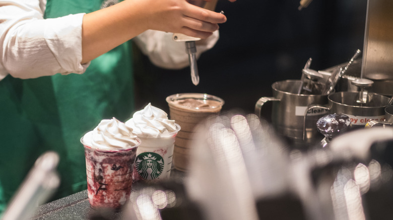 Starbucks barista making drinks