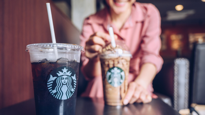 Person with Starbucks Frappuccino and iced coffee