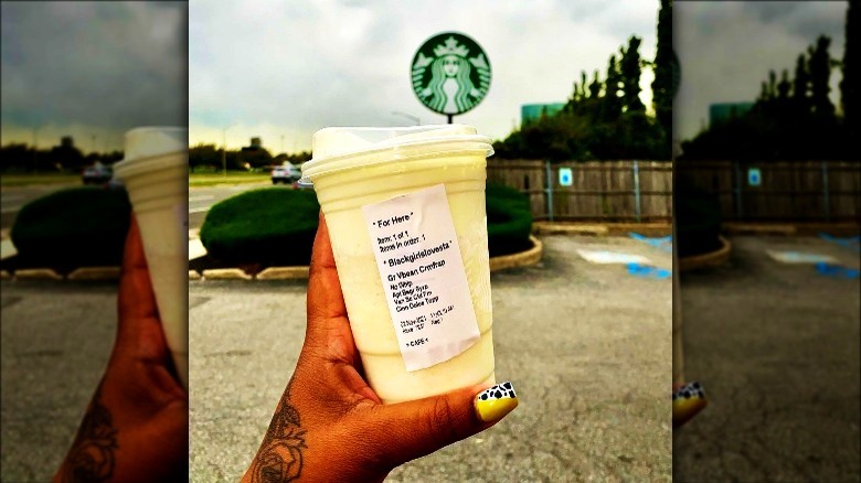 Hand holding Starbucks custom drink