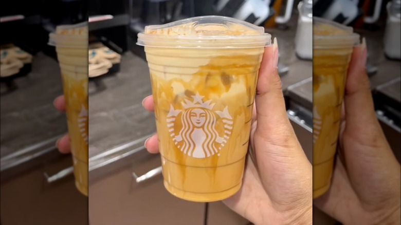 hand holding Sweet Pumpkin Latte