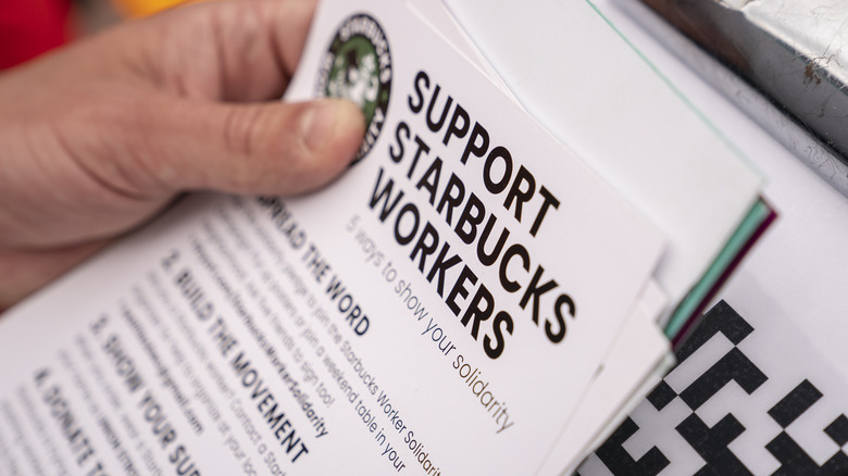 Person holding Starbucks union demands sheet