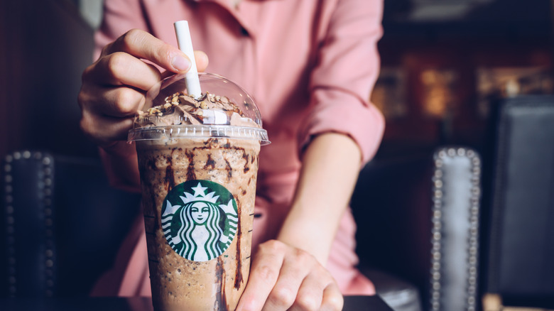 Person holding Frappuccino and straw