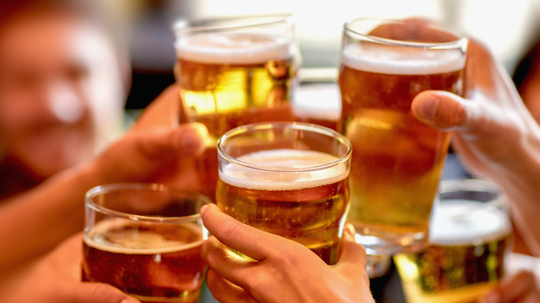 People raising glasses of beer