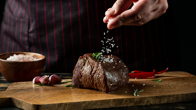 Person salting steak