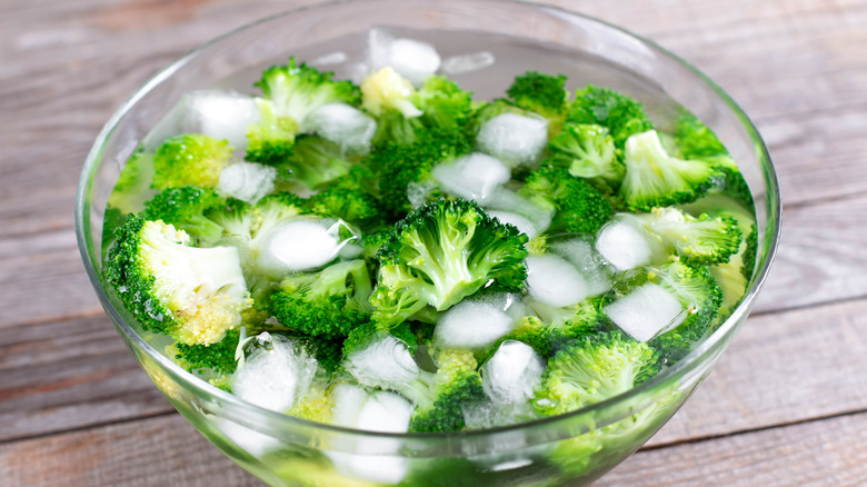 Broccoli resting in an bowl with water and ice 