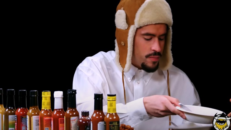 Bad Bunny holds ice cream on Hot Ones