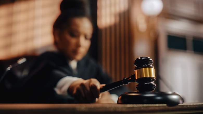 Black female judge banging gavel