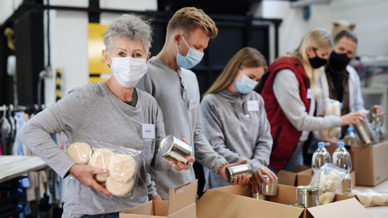 Volunteers packing food into boxes