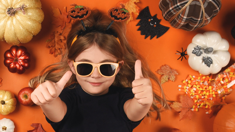 Girl with sunglasses and candy corn