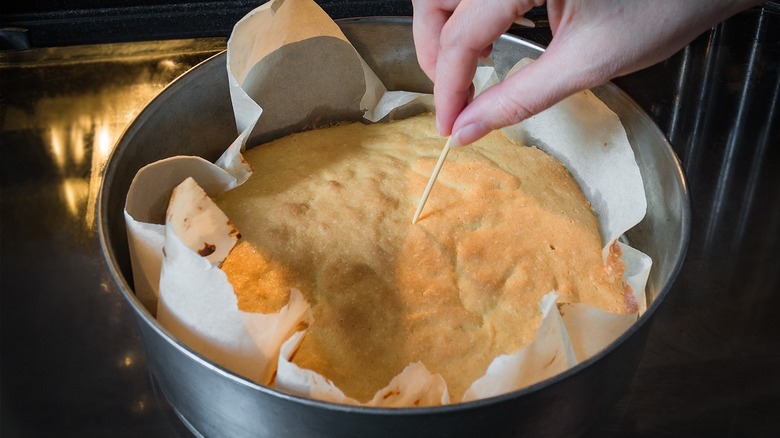 Toothpick inserted into cake to test doneness