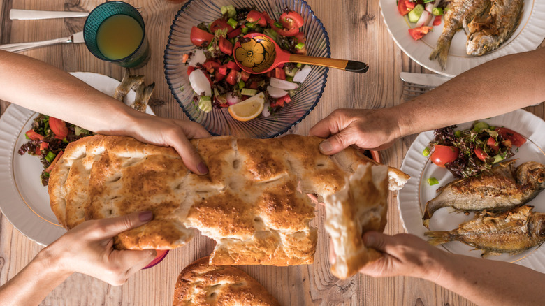 People breaking bread at Iftar meal